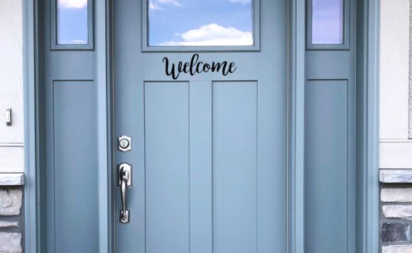 Front door of a home that says Welcome